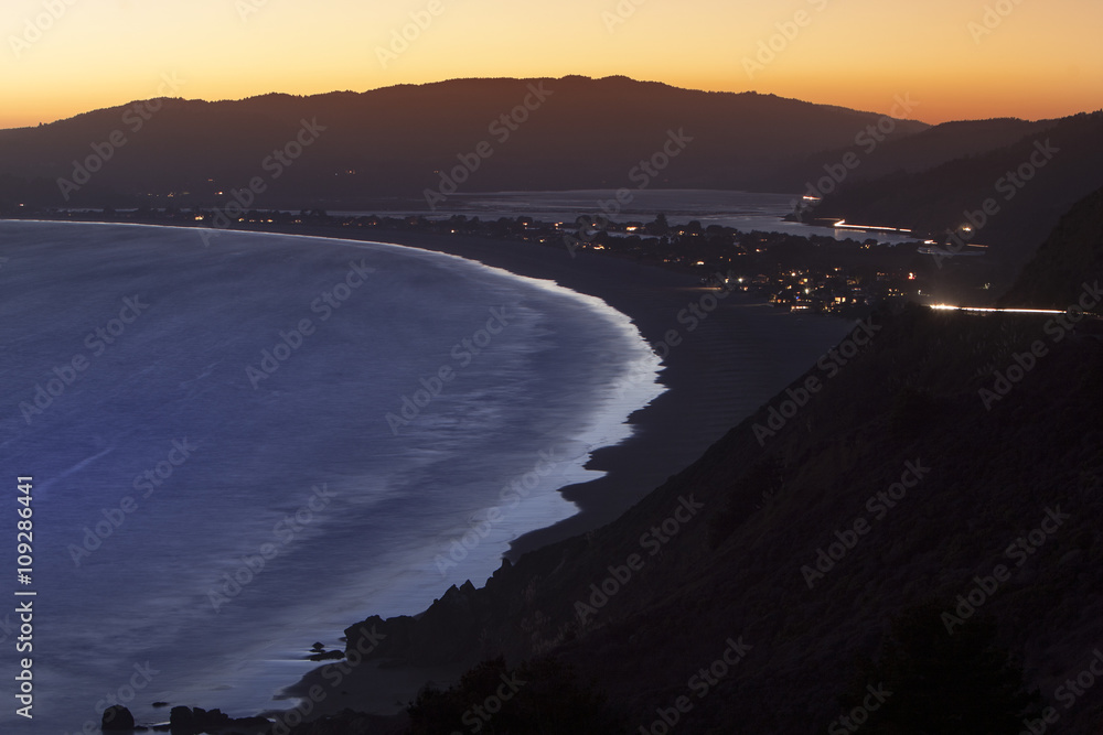 Beach in the coastal town or city on an ocean side at night. Highway 101 or Pacific Coast Highway, California, America. Beach in the coastal town or city on an ocean side at night. Highway 101 or Pacific Coast Highway, California, America.
