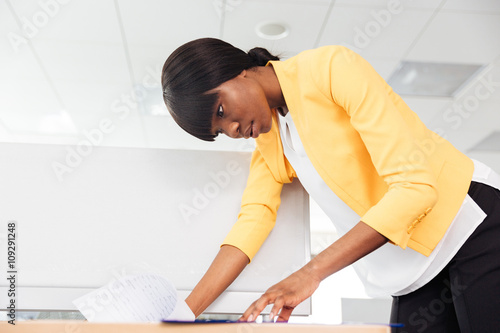 Businesswoman reading document in office