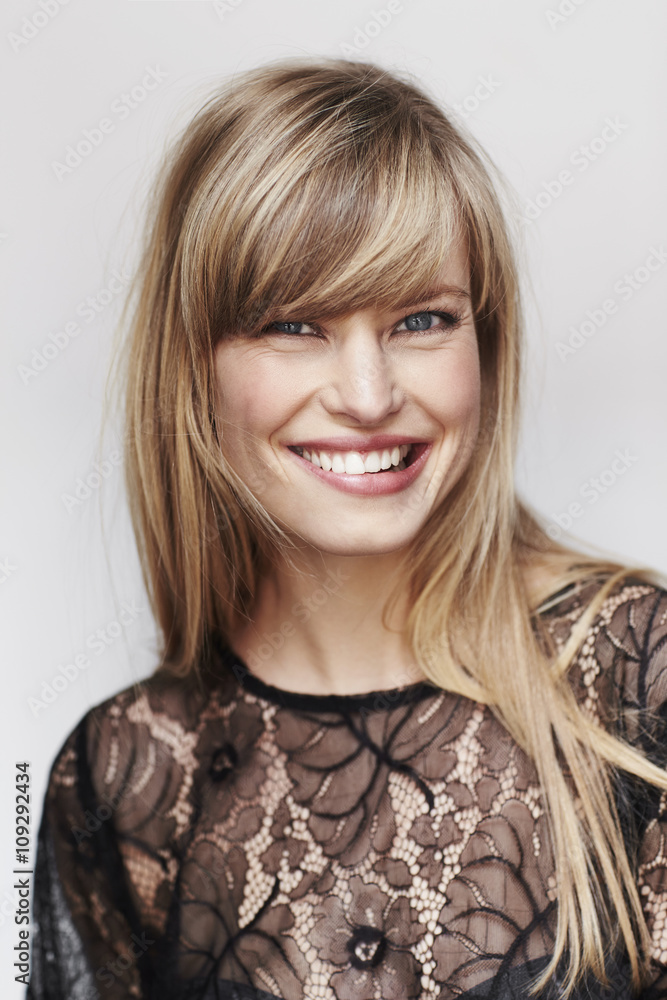 Smiling blond woman in studio wearing lace fashion Smiling blond woman in studio wearing lace fashion