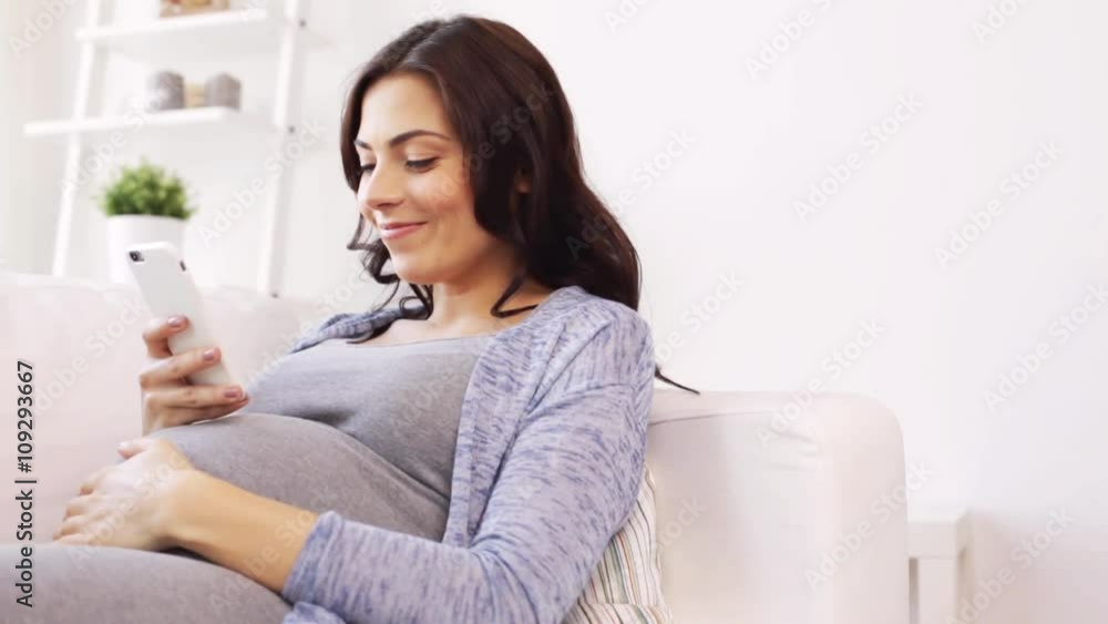 happy pregnant woman with smartphone at home happy pregnant woman with smartphone at home