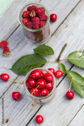 Fruits cherries raspberries wooden table