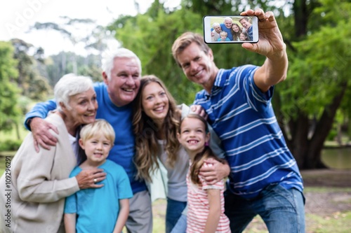 Multi-generation family taking a selfie in the park