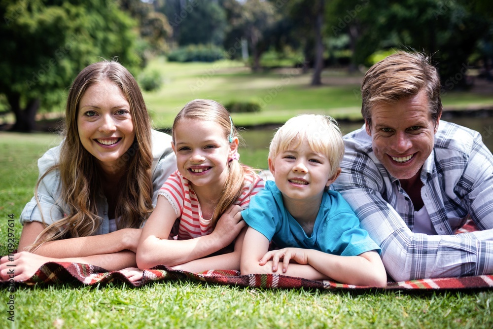 Happy family lying in the park Happy family lying in the park