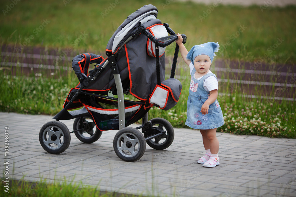 little funny girl with baby carriage little funny girl with baby carriage