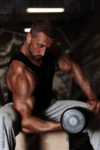 Training bodybuilder strong man arm workout