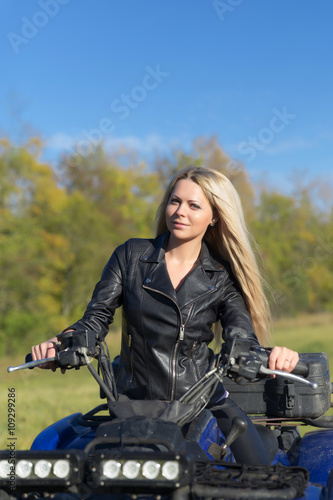 Elegant woman riding extreme quadrocycle ATV