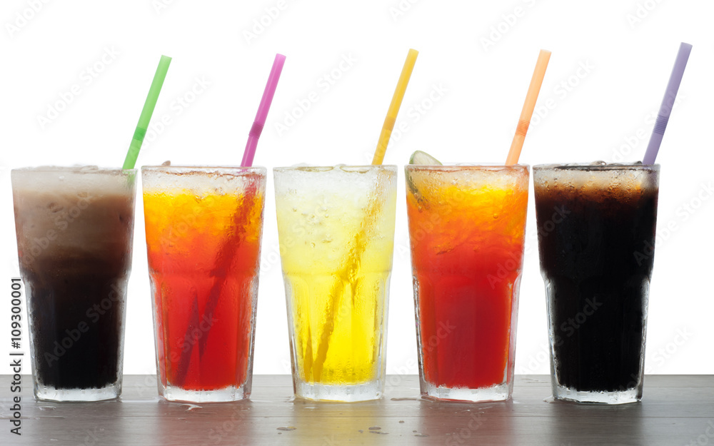 Four glasses of cold, fresh, homemade sodas with ice and drinkin Four glasses of cold, fresh, homemade sodas with ice and drinkin