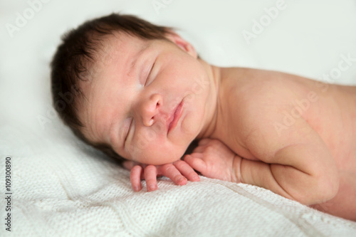 sleeping newborn baby on a blanket
