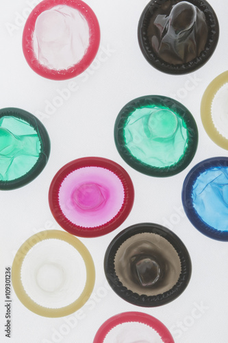 colorful condoms on White background