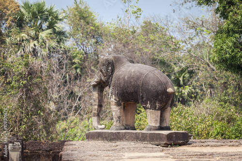 Elephant statue in East Mebon temple, Siem Reap, Cambodia. reen trees background