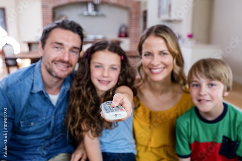 Family watching television in living room