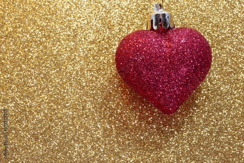 red heart on golden background shining photo