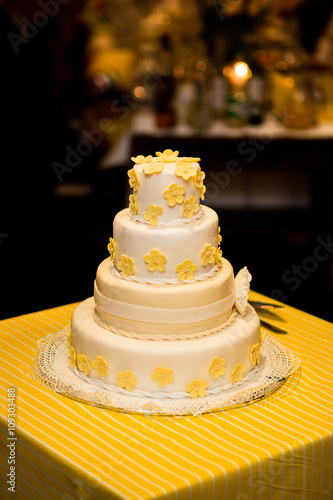 Image of a beautiful wedding cake with figurines of bride and groom at wedding reception