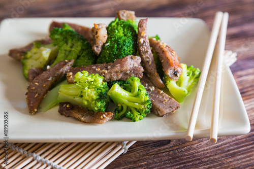 Asian cuisine, grilled meat with broccoli and sesame