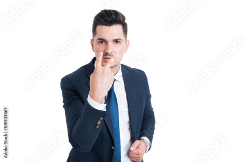 Businessman making look into my eyes and pay attention gesture