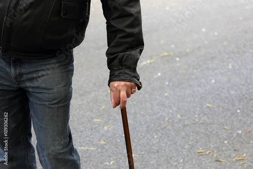 older man with walking stick