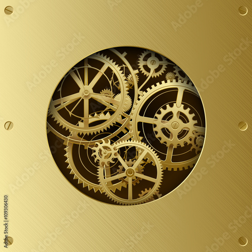 Metallic gear wheels in the brass plate with cut round hole
