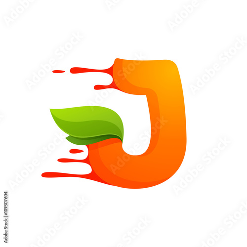 J letter with orange juice drops and leaves.