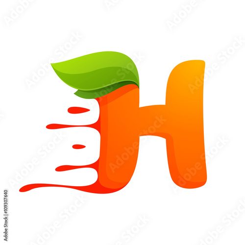 H letter with orange juice drops and leaves.