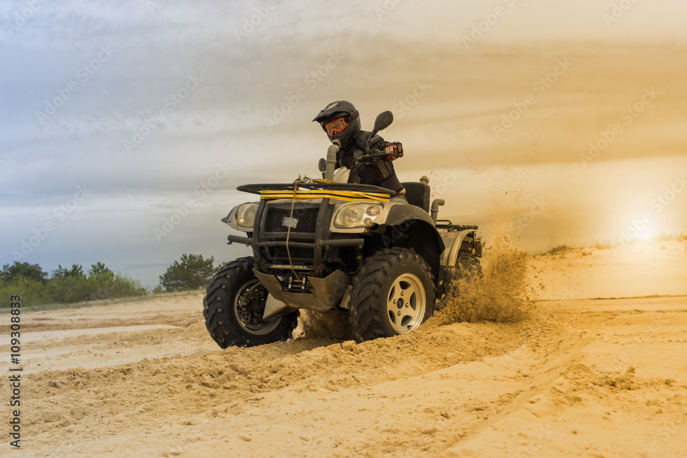 Racing ATV is sand. Racing ATV is sand.