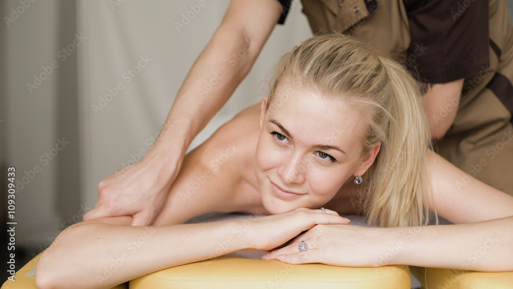 Fototapeta premium Woman in massage. Young attractive girl smiling with a massage.