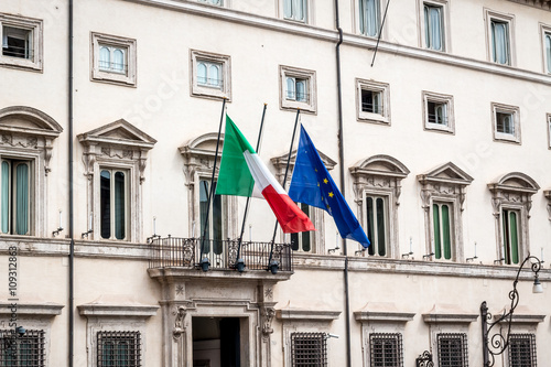 Italy and the European union flag on a building 