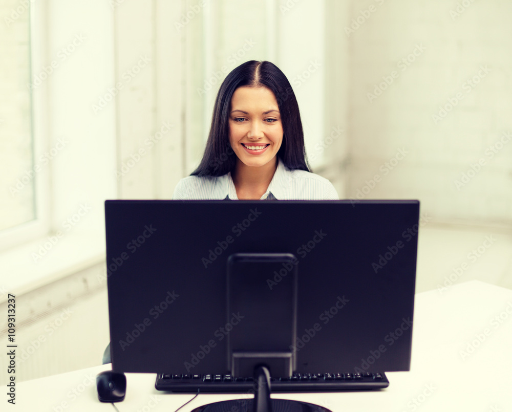 smiling businesswoman or student with computer