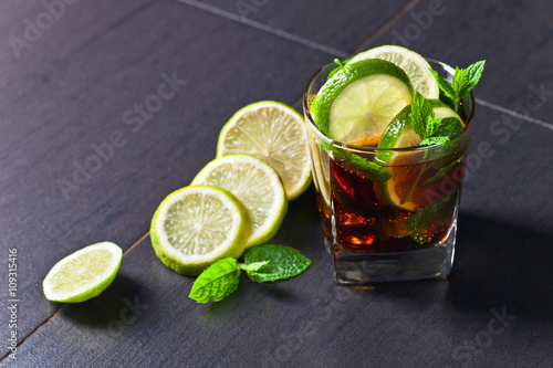 Photography cocktail Cuba libre with lime and peppermint leaves