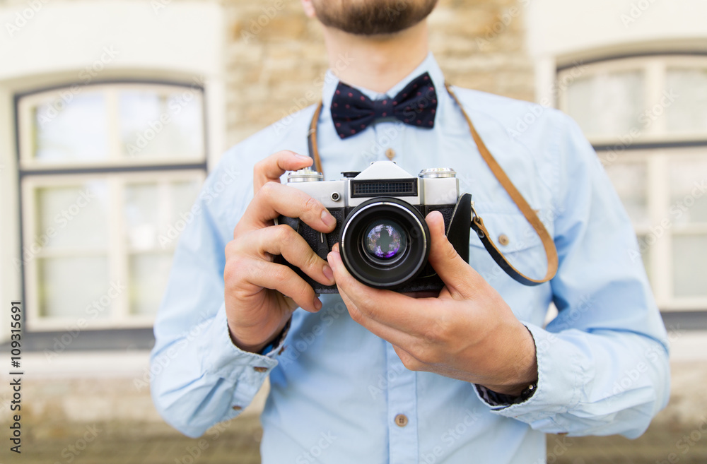 close up of hipster man with film camera in city close up of hipster man with film camera in city