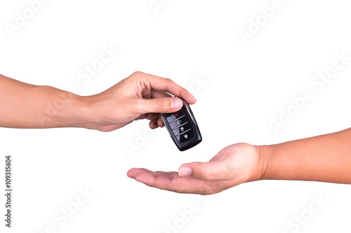 man hand giving car remote to another hand