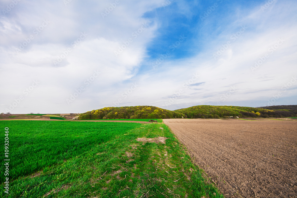 plowed field and cloudy sky in sunset plowed field and cloudy sky in sunset