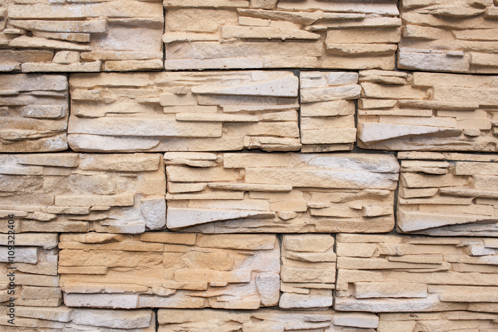 Wall is faced with tiles of  sandstone