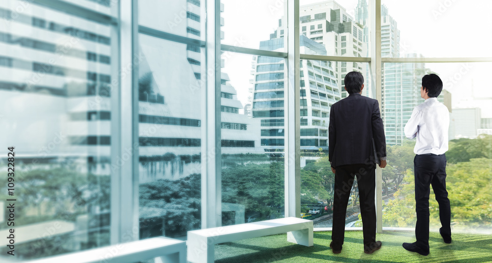 Businessman looking at city Businessman looking at city