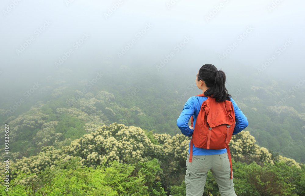 young  woman hiker enjoy the view on mountain peak