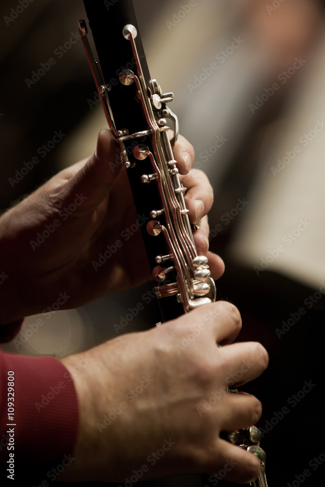 Fototapeta premium Human hands playing a clarinet closeup