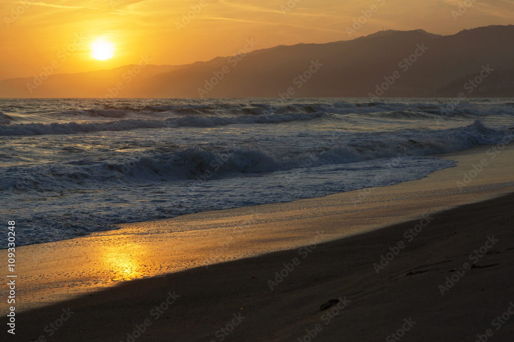 The Pacific ocean during sunset. Landscape with blue sea, the mountains and the dusk sky, the USA, Santa Monica. 