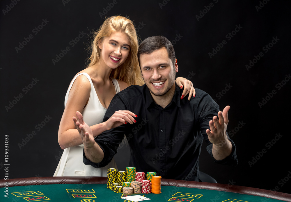 Young couple playing poker have a good time in casino Young couple playing poker have a good time in casino