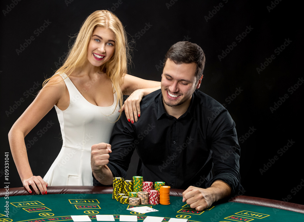 Young couple playing poker have a good time in casino Young couple playing poker have a good time in casino