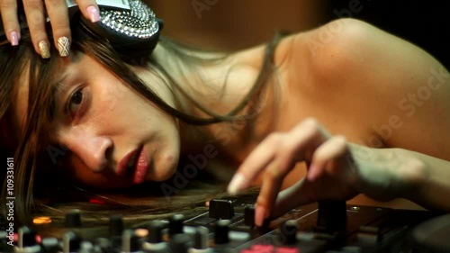 DJ-girl is making loud on sound mixer