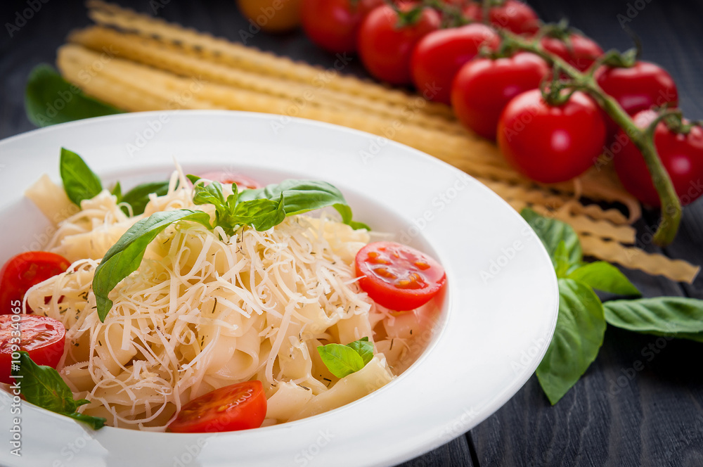 plate of italian pasta with tomatoes, basil and cheese plate of italian pasta with tomatoes, basil and cheese