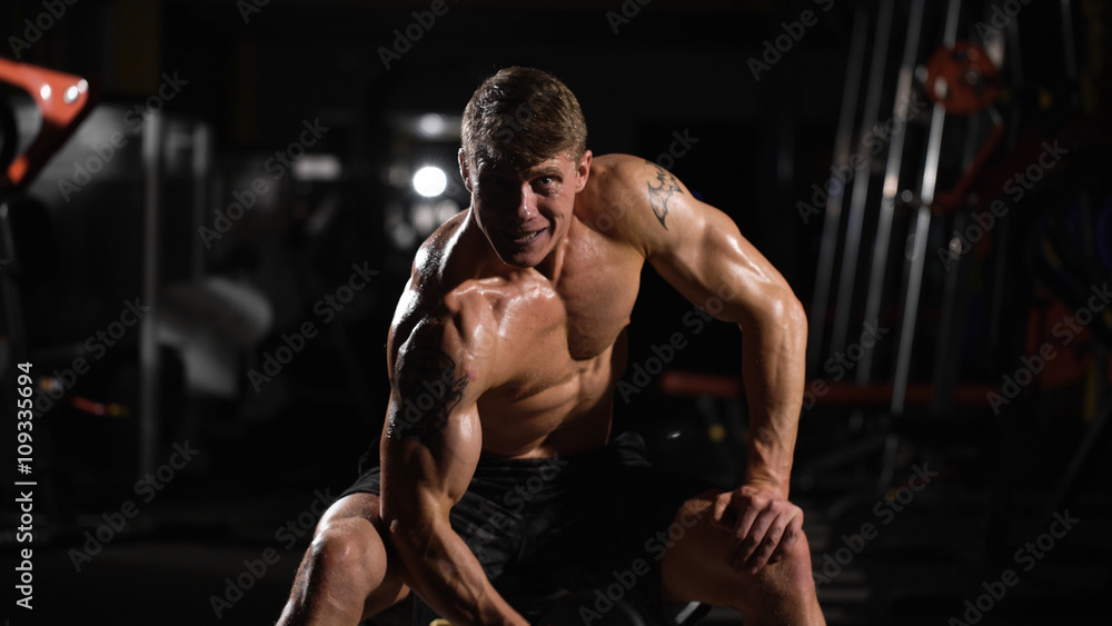 Fototapeta premium On the limit. handsome young man doing exercises for the biceps