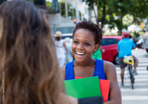 Afrikanische Studentin trifft Freundin in der Stadt photo