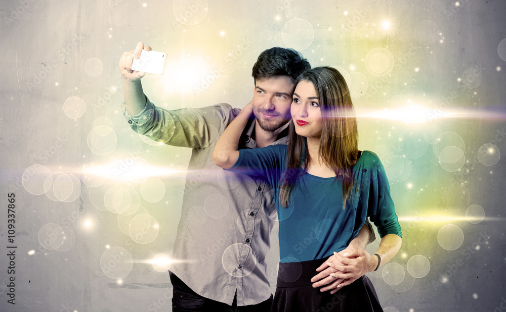 Smiling couple taking selfie in glitter light Smiling couple taking selfie in glitter light