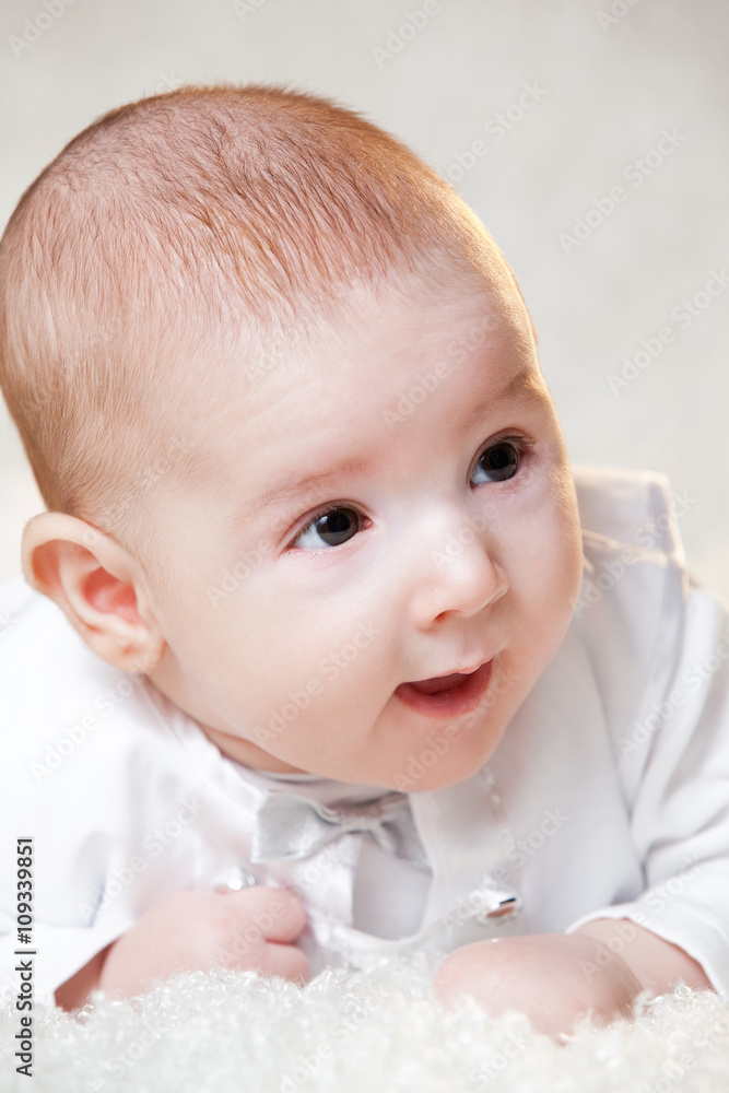 newborn baby in a beautiful white dress on a light background , portrait . newborn baby in a beautiful white dress on a light background , portrait .
