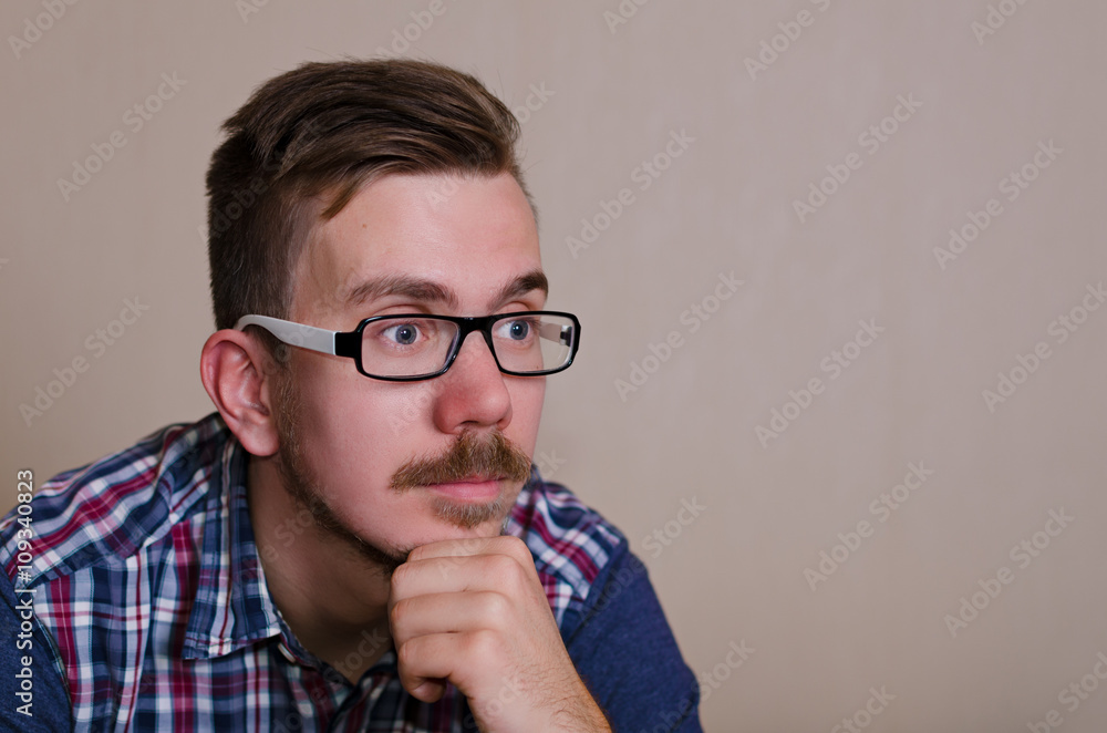 Man looking to the camera and dreaming. copy space for a text. hipster in glasses and with beard thinking. Man looking to the camera and dreaming. copy space for a text. hipster in glasses and with beard thinking.