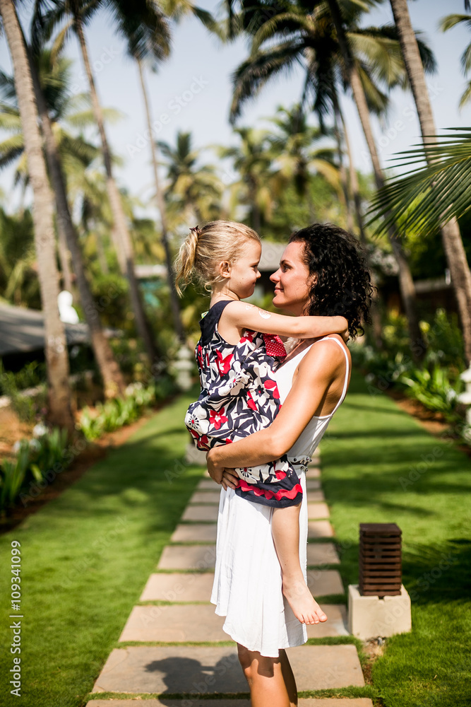 Naklejka premium mother and preteen daughter summer portrait in the green beautiful park