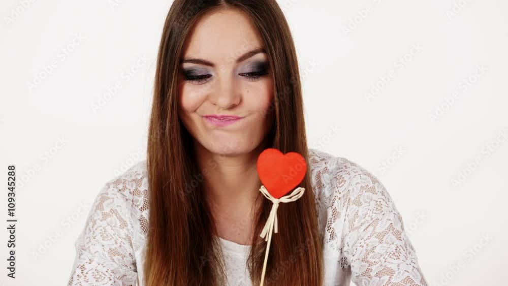 Woman holding red heart love symbol thinking 4K Woman holding red heart love symbol thinking 4K