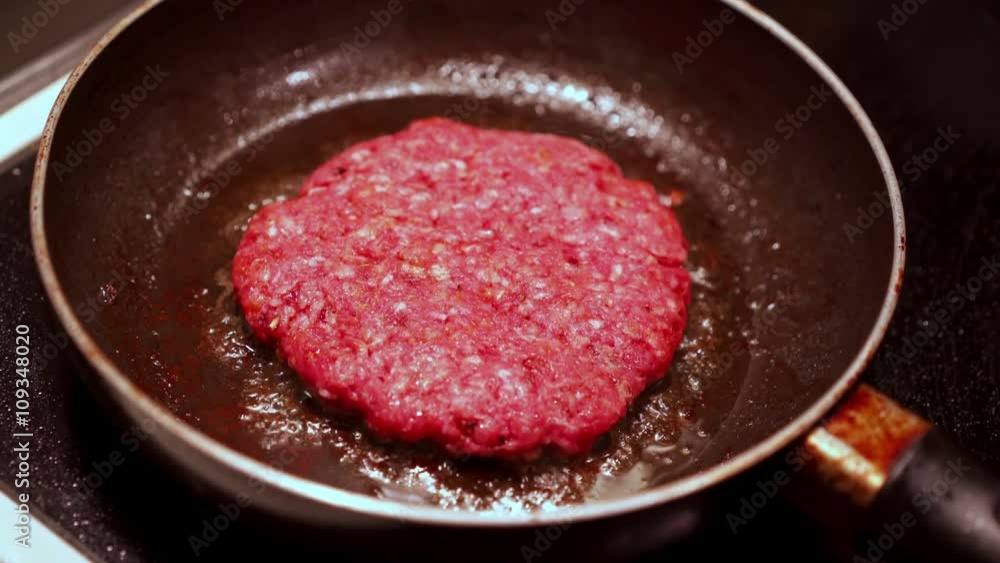 Hamburger meat being cooked on kitchen stove in skillet.
Hamburger meat being cooked on kitchen stove in skillet.