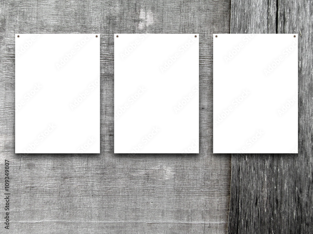 Fototapeta premium Close-up of three nailed blank frames on grey weathered wooden boards background