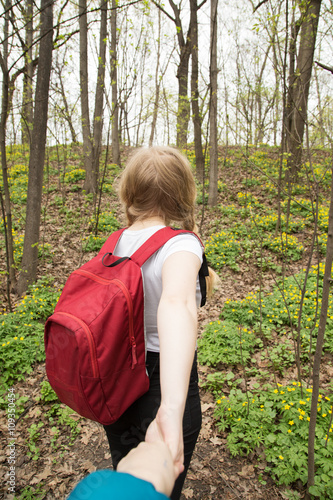 young woman backpacker hiking in the forest, follow me style